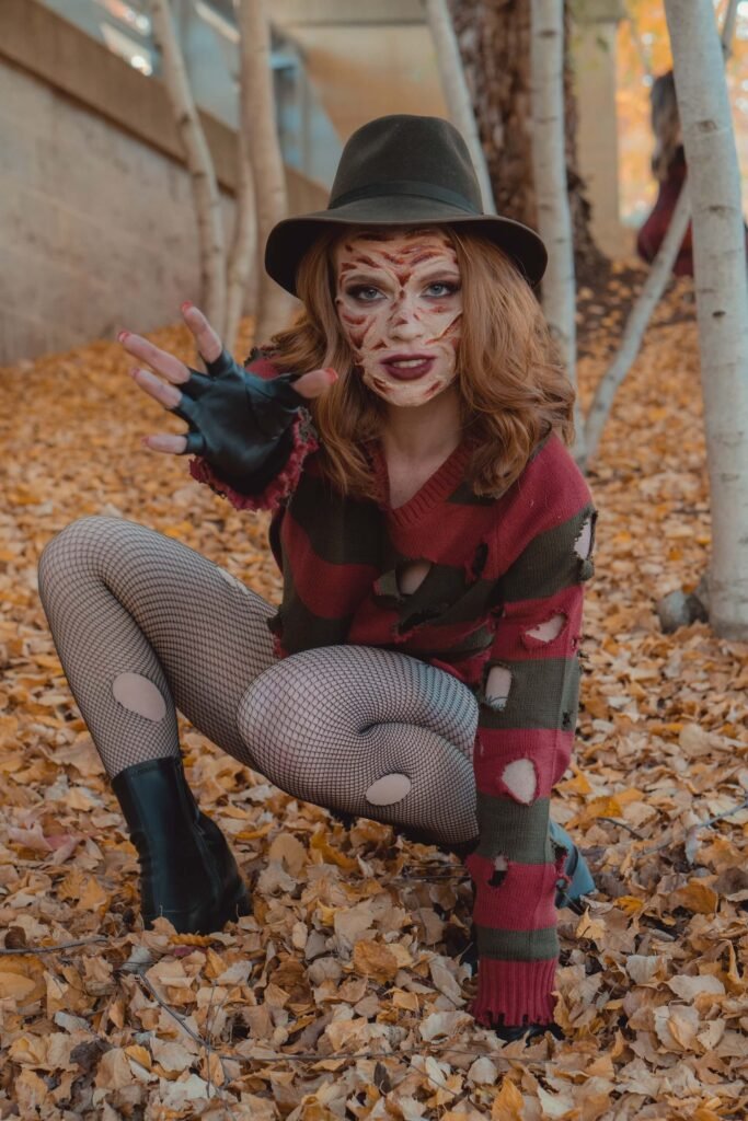 A woman is dressed up as the female Halloween character Freddy Krueger.