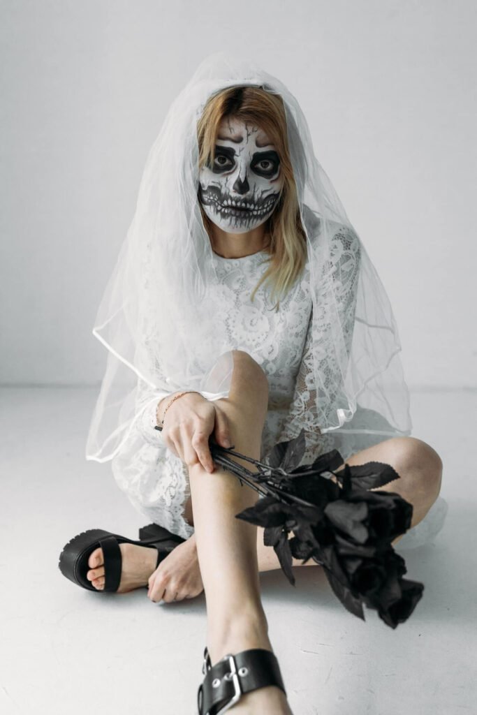 A woman is dressed up in a skeleton Halloween costume
