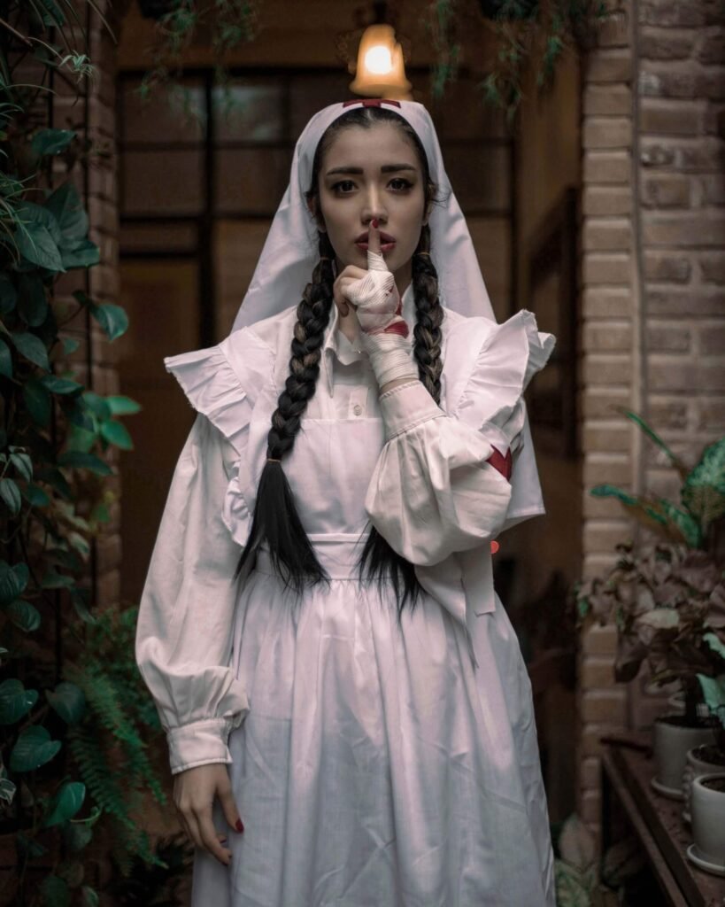 A woman is dressed up in a Victorian nurse Halloween costume.