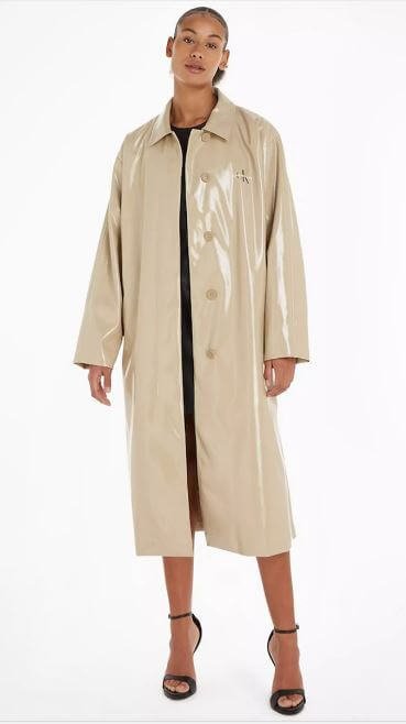A woman wears a PVC raincoat by Calvin Klein.