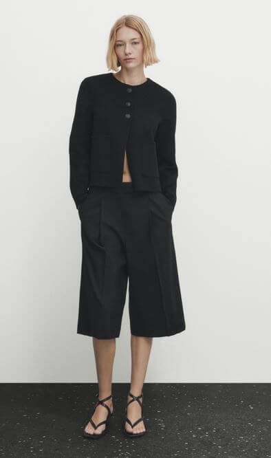A woman wears a cropped wool blend jacket by Massimo Dutti.