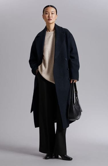 Autumn coats, a woman wears a belted wool coat.
