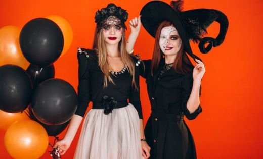 Two women are dressed in Halloween costumes.