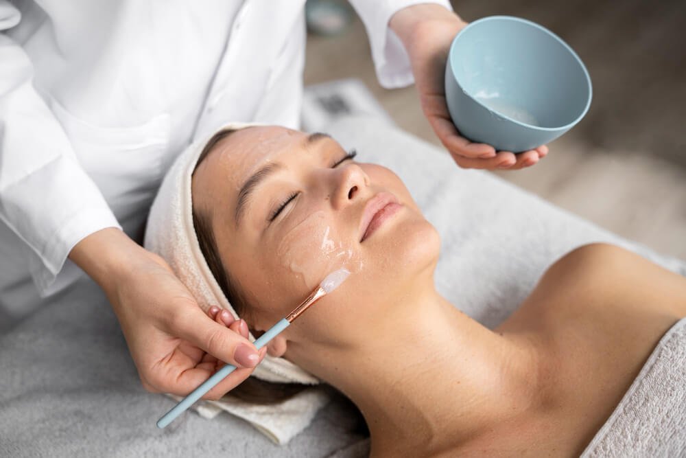 What is an enzyme facial? A woman is getting a professional facial.