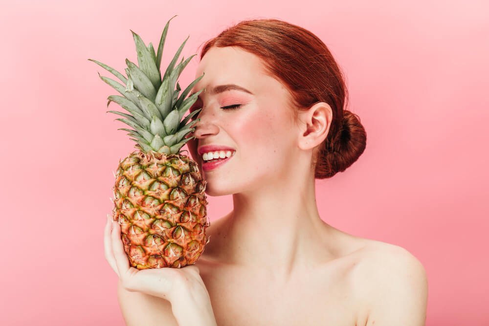 What is an enzyme facial treatment?
A girl with beautiful skin holds a pineapple.