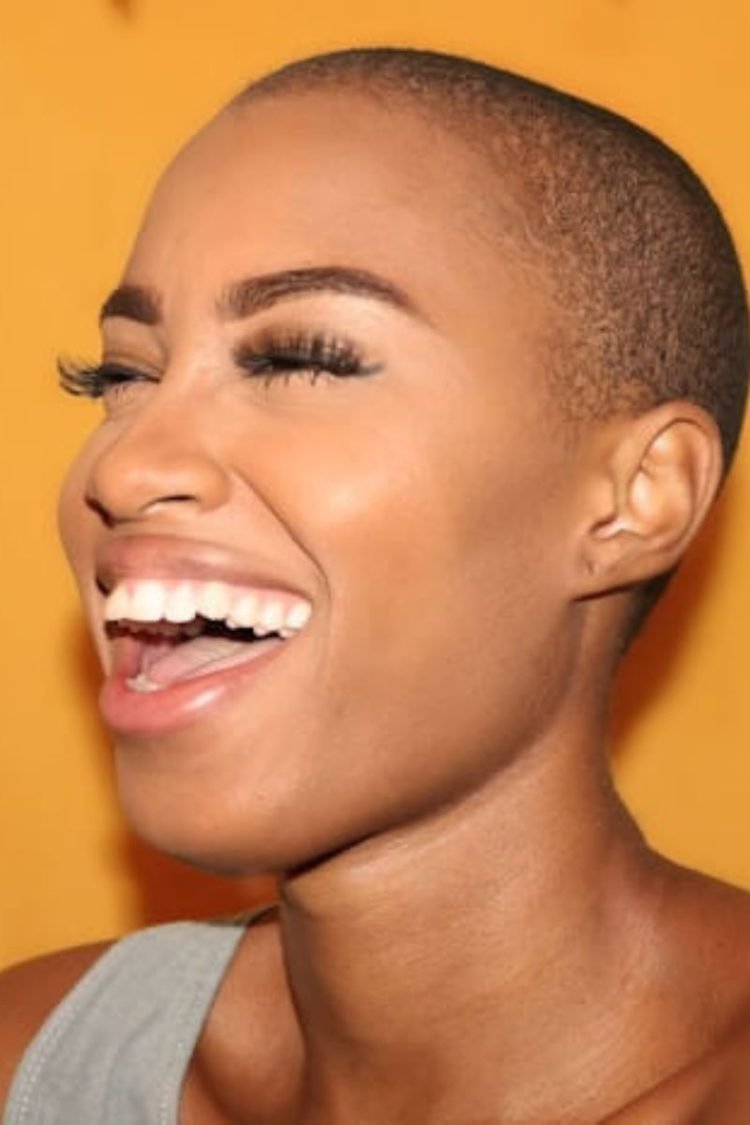 A woman with very white teeth is smiling