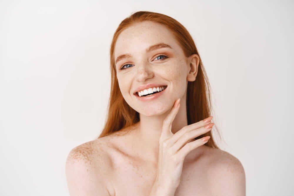 What is a European Facial? A picture of woman with red hair and healthy glowing skin.