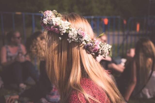 A woman at a music festival wears a Boho flower crown