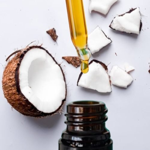 A bottle of argan oil and some coconut oil: Argan oil vs coconut oil for hair