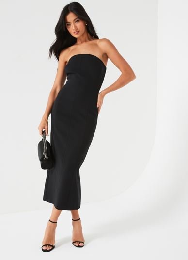 A model wears a long strapless black dress