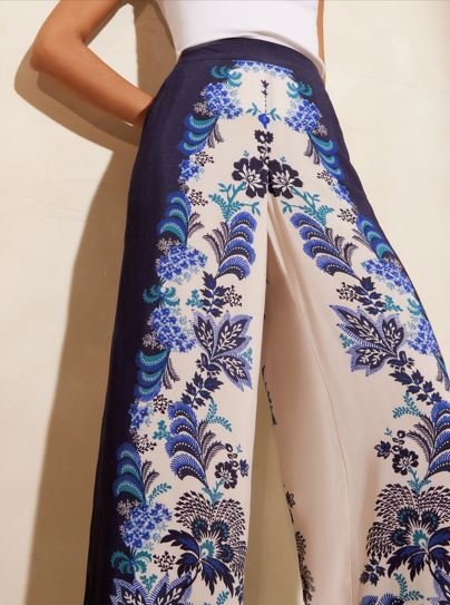 A model wears a pair of blue and white floral trousers.
What to wear on holiday in the evening