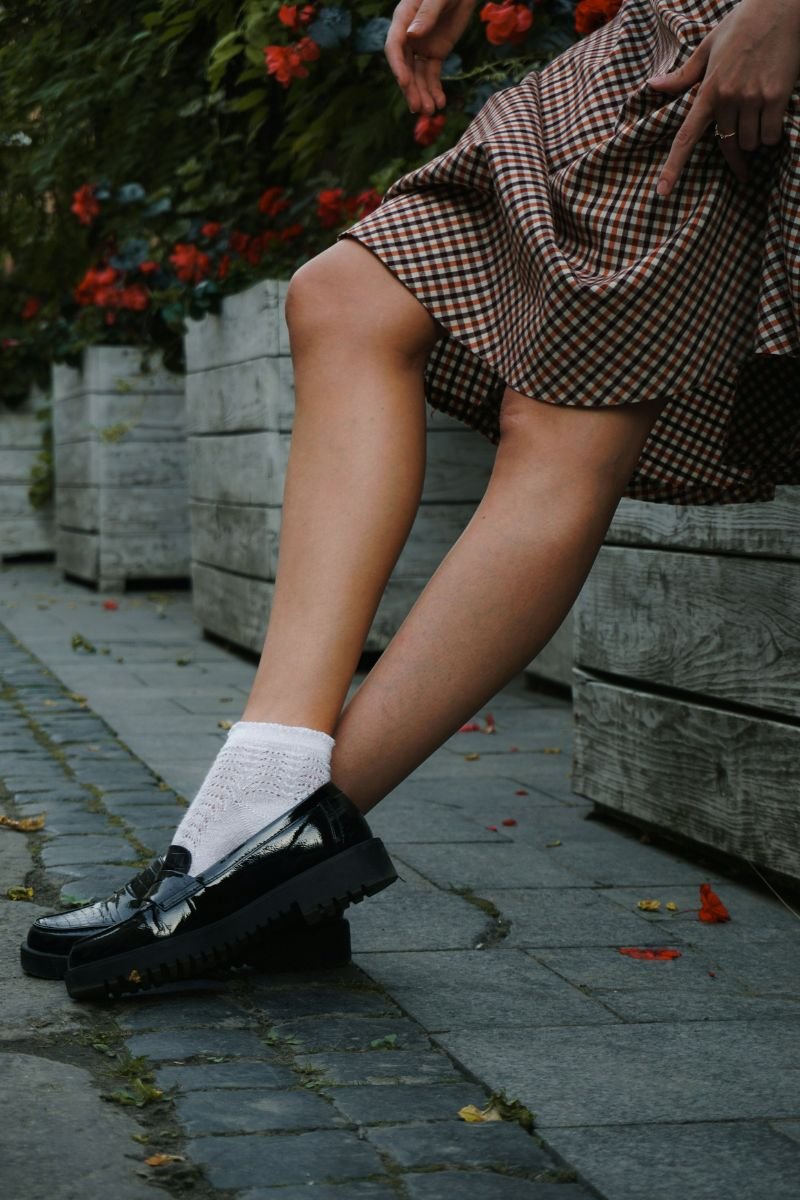 Shoe capsule wardrobe: A girl wears a pair of black loafers