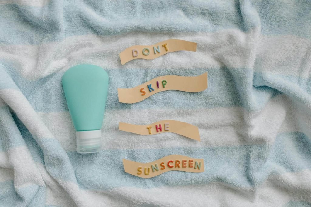 A striped towel with a bottle of sunscreen.
How to protect different tanning skin types