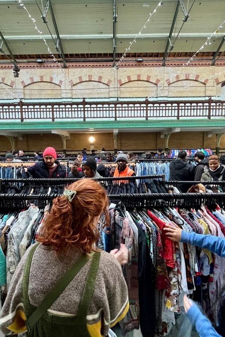 A woman browsing at a vintage fair.