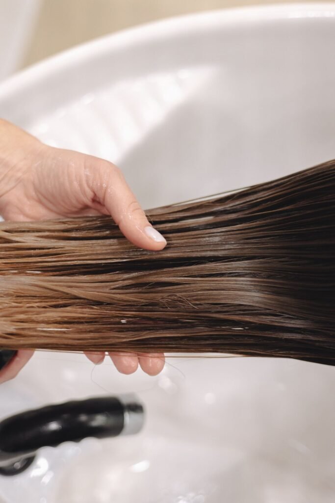 Benefits Of A Collagen Hair Treatment
A woman with long brown hair is getting a hair treatment.