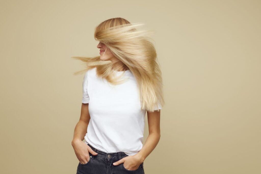 Collagen Or Keratin: Which Is Better For Hair?
A woman in a white t-shirt waves her long, shiny blonde hair around