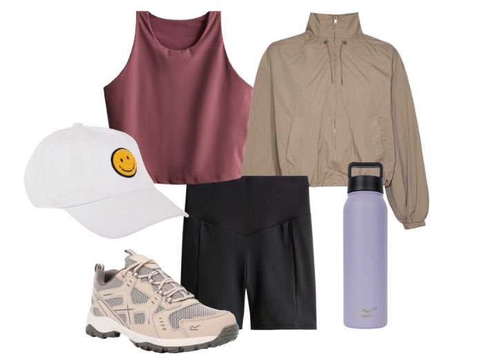 Gym Outfts: A plum crop vest rop, black cycling shorts, a white cap with a yelo smiley face, a lilac water bottle a waterproof jacket, and walkking trainers.