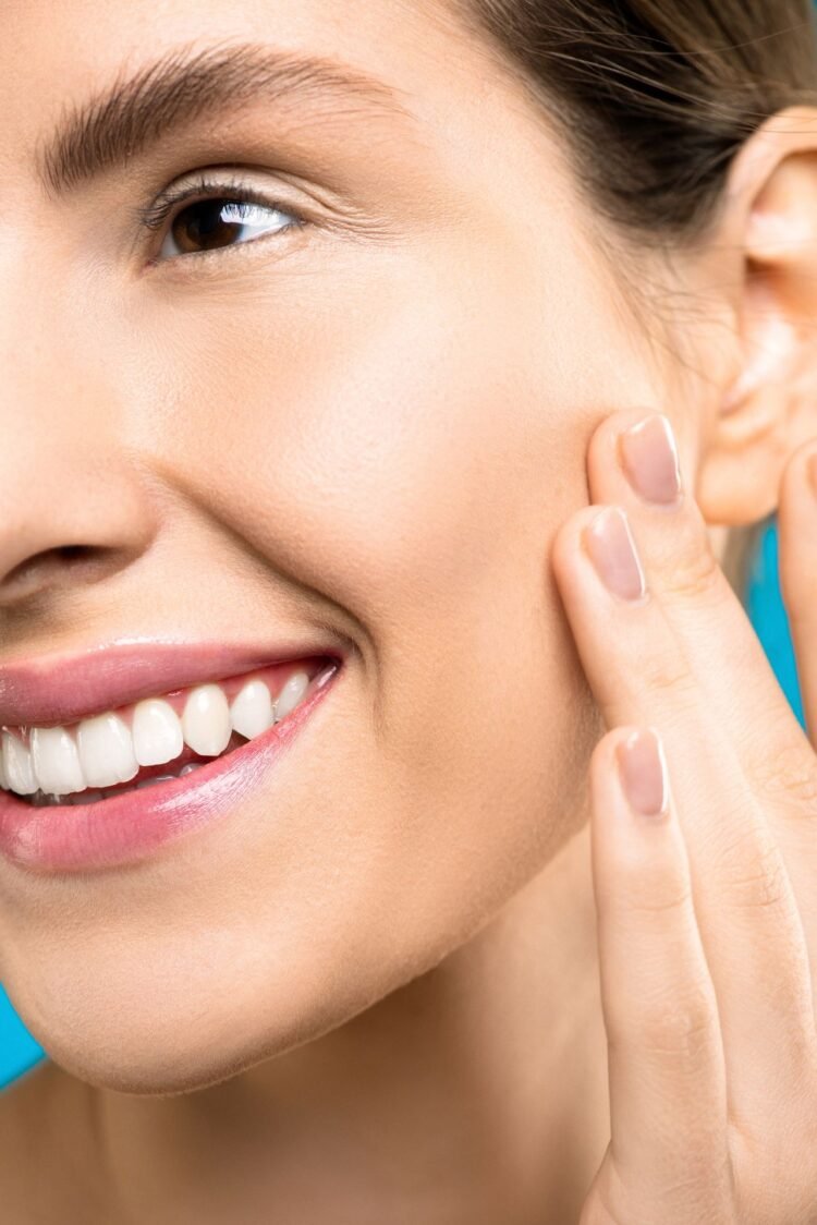 A close up of a woan with healthy and glowing skin
